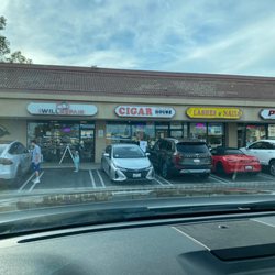 Cigar House - Outside. Busy parking.