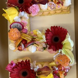 Vanilla cake with a strawberry filling. Notice the macrons, candies, and fresh fruit as well as the beautiful flowers!!