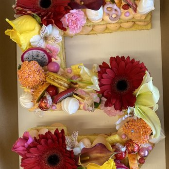 Astoria Cafe & Bakery - Geneva  - Vanilla cake with a strawberry filling. Notice the macrons, candies, and fresh fruit as well as the beautiful flowers!! - Desserts Near Me - Geneva, Illinois