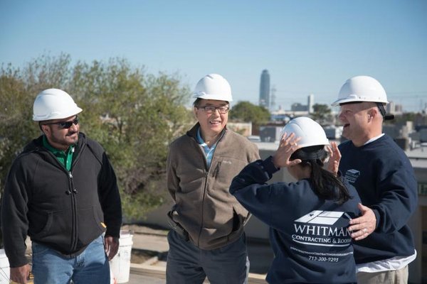 Whitman's Contracting And Roofing Logo