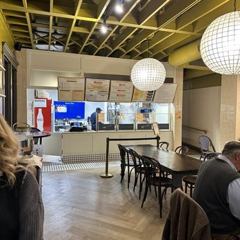 A'mano Fresh Pasta - a man and a woman sitting at a table in a restaurant - Pasta Shops Near Me - Williamsville, New York
