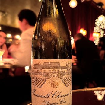 The Nines - a bottle of wine on a table - New American Near Me - New York, New York