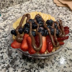 My boyfriend's small açaà bowl with fruit, granola, Nutella and honey.