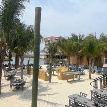 Saltwater 75 - Outside dining on the bay or indoor open air seating with a clean, bright nautical decor. - Seafood Near Me - Ocean City, Maryland