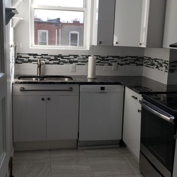 Supreme Kitchens & Baths - a clean kitchen with white cabinets - General Contractors Near Me - Freeport, New York
