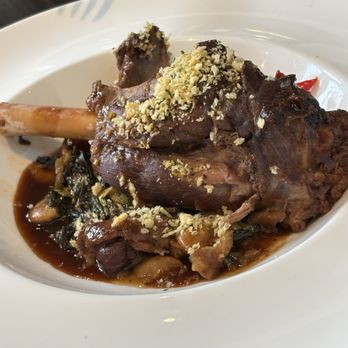 American Bounty Restaurant - - BRAISED LAMB SHANK: Braised Greens & White Beans, Brussels sprouts Gremolata, Pickled Jimmy Nardello Peppers, Lamb Jus - New American Near Me - Hyde Park, New York