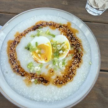 MAKE Cafe - Ginger Rice Congee Warm rice porridge- with chilli sauce and hard boiled egg. Delish! - Breakfast & Brunch Near Me - San Diego, California MAKE Cafe - Ginger Rice Congee Warm rice porridge- with chilli sauce and hard boiled egg. Delish! - Breakfast & Brunch Near Me - San Diego, California