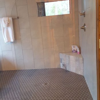 Broken Bow Vacation Cabins - dual head shower with a window view of the hot tub and fireplace on the back porch - Vacation Rentals Near Me - Broken Bow, Oklahoma