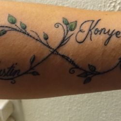 Montana Tattoo Company - My husband drew the base idea, but she added the flair of the leaves and fine lined vines. I LOVE IT!!