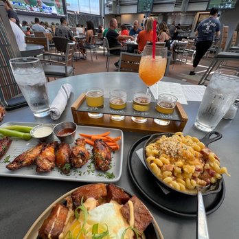 The Front Yard - Smoked and beer brined Chicken wings, bacon Mac and cheese, pork belly and Kimchi fries, light beer flight,  and a peach punch cocktail. - Beer Gardens Near Me - Las Vegas, Nevada
