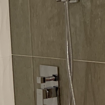 Kitchen Cabinets Express - Amazing gold metallic glass faced wall tiles in shower that look like raining gold. Top shelf shower fixtures solid brass/ Chrome finish. - General Contractors Near Me - Buena Park, California