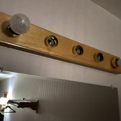 Prospector Inn - Bathroom lighting - very frugal with bulbs. Note the stylish avant-garde mismatched bulb profiles.