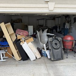 Helping Hand Junk Removal - Clutter has taken over the garage leaving no more parking spaces