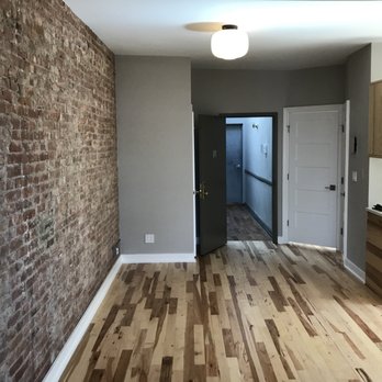 New Amsterdam Builders - a brick wall and hardwood floors - General Contractors Near Me - Sunnyside, New York New Amsterdam Builders - a brick wall and hardwood floors - General Contractors Near Me - Sunnyside, New York
