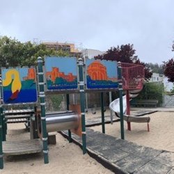 Cow Hollow Playground - Lower level with climbing structure and slide. Swings in the background (baby swings on the upper level) and some arm rings