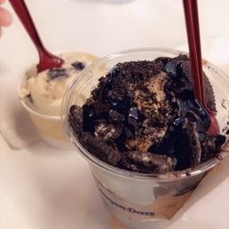 a cup of ice cream and a spoon a cup of ice cream and a spoon