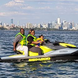 Rent Our Ski - Toronto & Scarborough Jet Ski Rentals - Family on Jet Ski with Toronto Skyline in the back