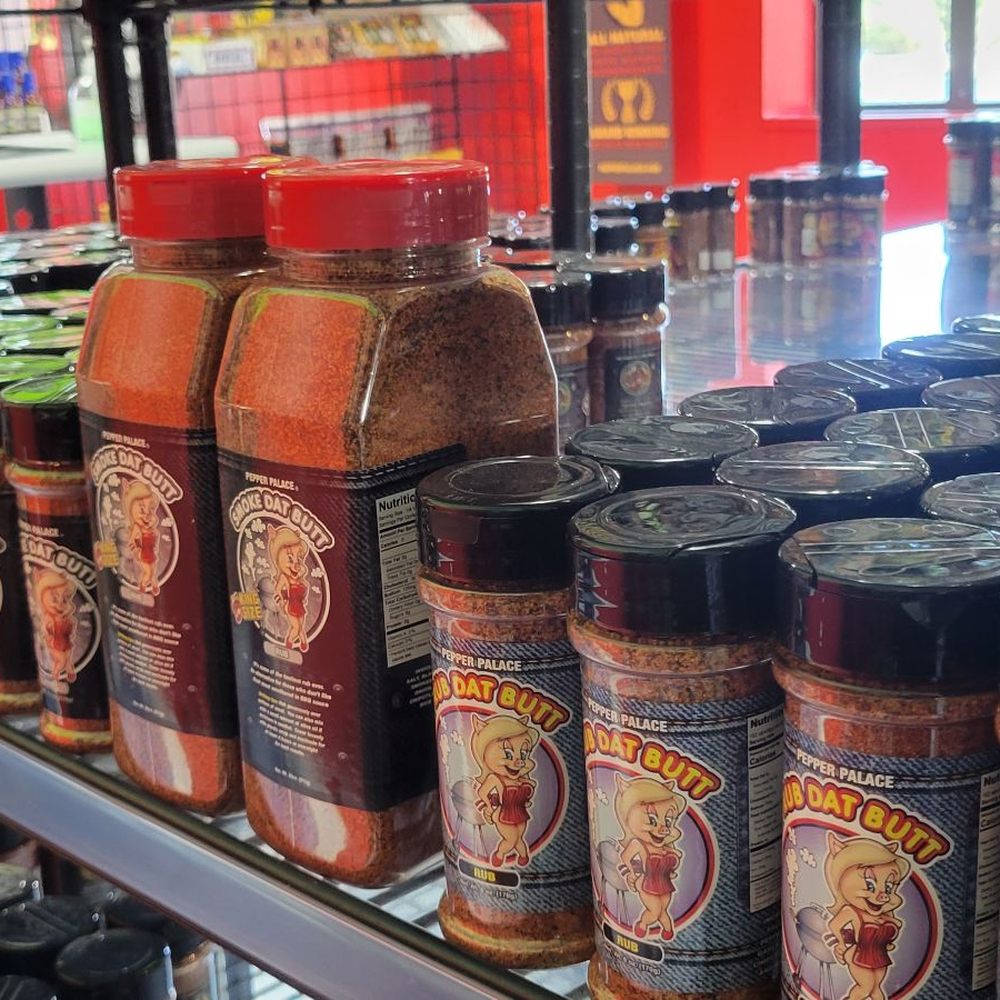 a shelf full of pepper sauces