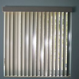 All About Blinds and Shutters. Jacksonville, FL. Vertical blinds, gray fabric panel. All About Blinds and Shutters. Jacksonville, FL. Vertical blinds, gray fabric panel.