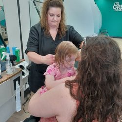 Me holding my daughter while getting her haircut!