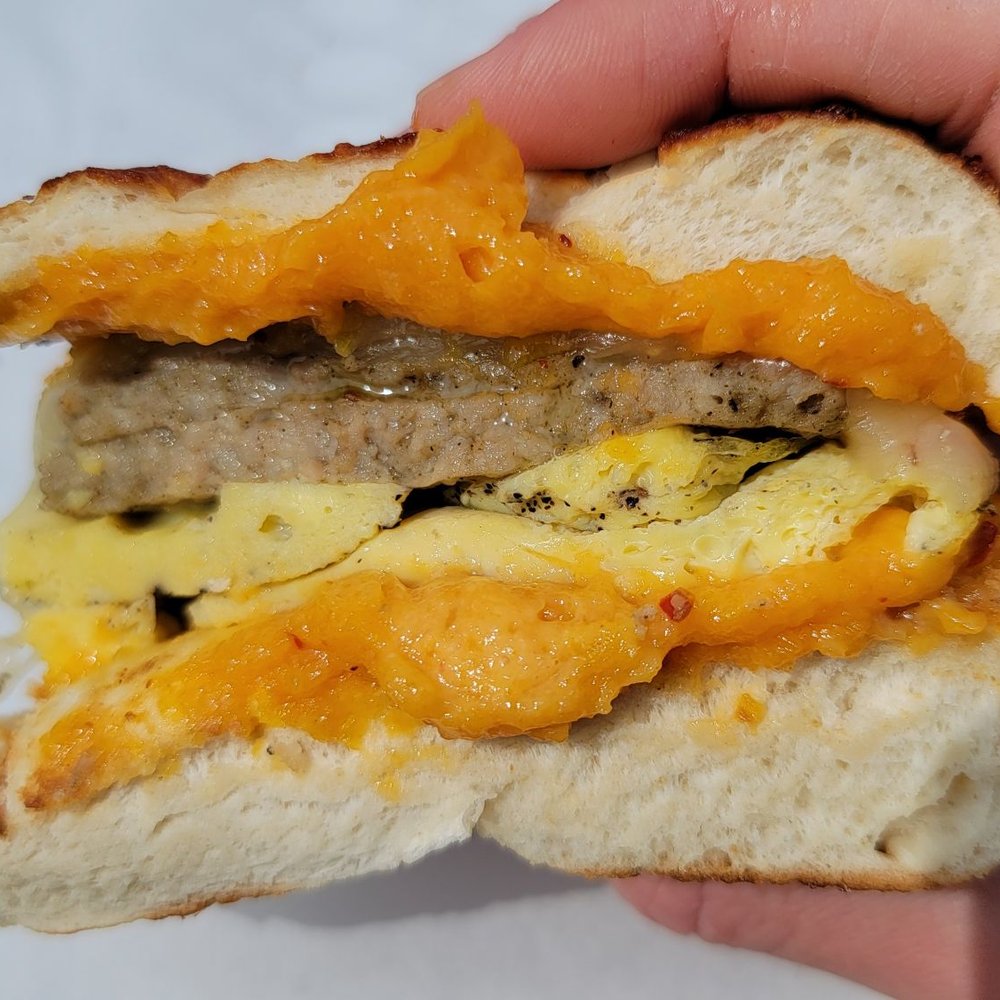 Undergrounds Coffee House and Roastery - The Colonel Francisco on toasted asiago bagel: Absolutely love the apricot chipotle spread oozing out on the top and bottom! - Coffee Roasteries Near Me - Buffalo, New York