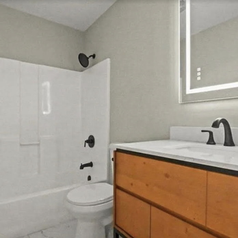 Gold Standard Construction - a bathroom with a toilet, sink, and shower - General Contractors Near Me Gold Standard Construction - a bathroom with a toilet, sink, and shower - General Contractors Near Me