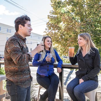 Graystone Brewing - a man and two women drinking beer - Breweries Near Me - Fredericton, New Brunswick