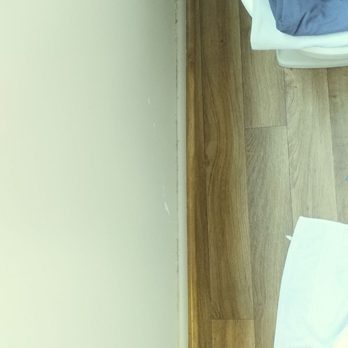Empire Today - Note how the wood linoleum is crooked compared to the wall. - Carpet Installation Near Me Empire Today - Note how the wood linoleum is crooked compared to the wall. - Carpet Installation Near Me