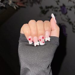 Nirvana Nails & Spa - Valentine inspired nails with bows that's been on for 2 weeks. Money definitely well spent.