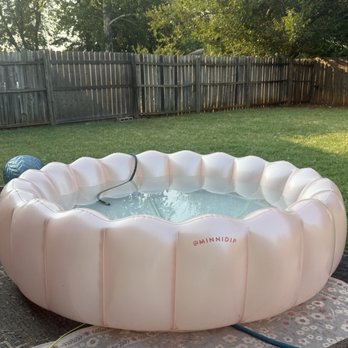 EZ Green - Mowed yard and a pink shell blow up pool - Lawn Services Near Me