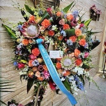 Colma Floral Shop - Custom funeral wreath with specific vision and challenging (orange/light blue) color palette. - Florists Near Me - Colma, California Colma Floral Shop - Custom funeral wreath with specific vision and challenging (orange/light blue) color palette. - Florists Near Me - Colma, California