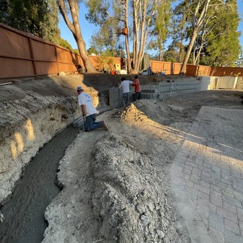 Blue Diamond Concrete Construction - two men working on a retaining wall - Landscaping Near Me Blue Diamond Concrete Construction - two men working on a retaining wall - Landscaping Near Me