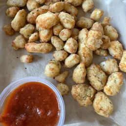 Cheese curds with marinara dipping sauce. Cheese curds with marinara dipping sauce.