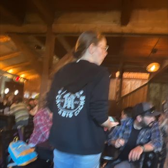 Alice's Champagne Palace - Our waitress serving the table next to us. - Bars Near Me - Homer, Alaska