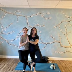 Lorenzen Studios - The owner Charla & a friend in our beautiful and peaceful yoga sanctuary with live plants, natural light & wood floors