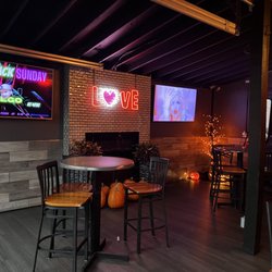 Just John Nightclub - Seating inside by outside entrance with fireplace