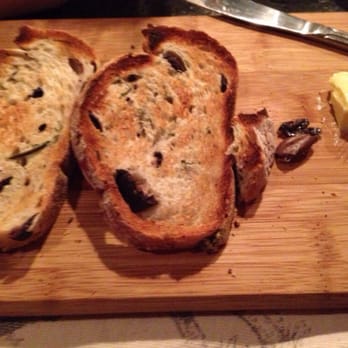 District Table and Bar - This bread is delicious. It has kalamata olives and Rosemary. It comes with grass fed butter. - New American Near Me - Stuart, Florida