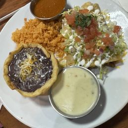 Enchiladas. One chicken and one beef with the red sauce and queso on the side. Enchiladas. One chicken and one beef with the red sauce and queso on the side.