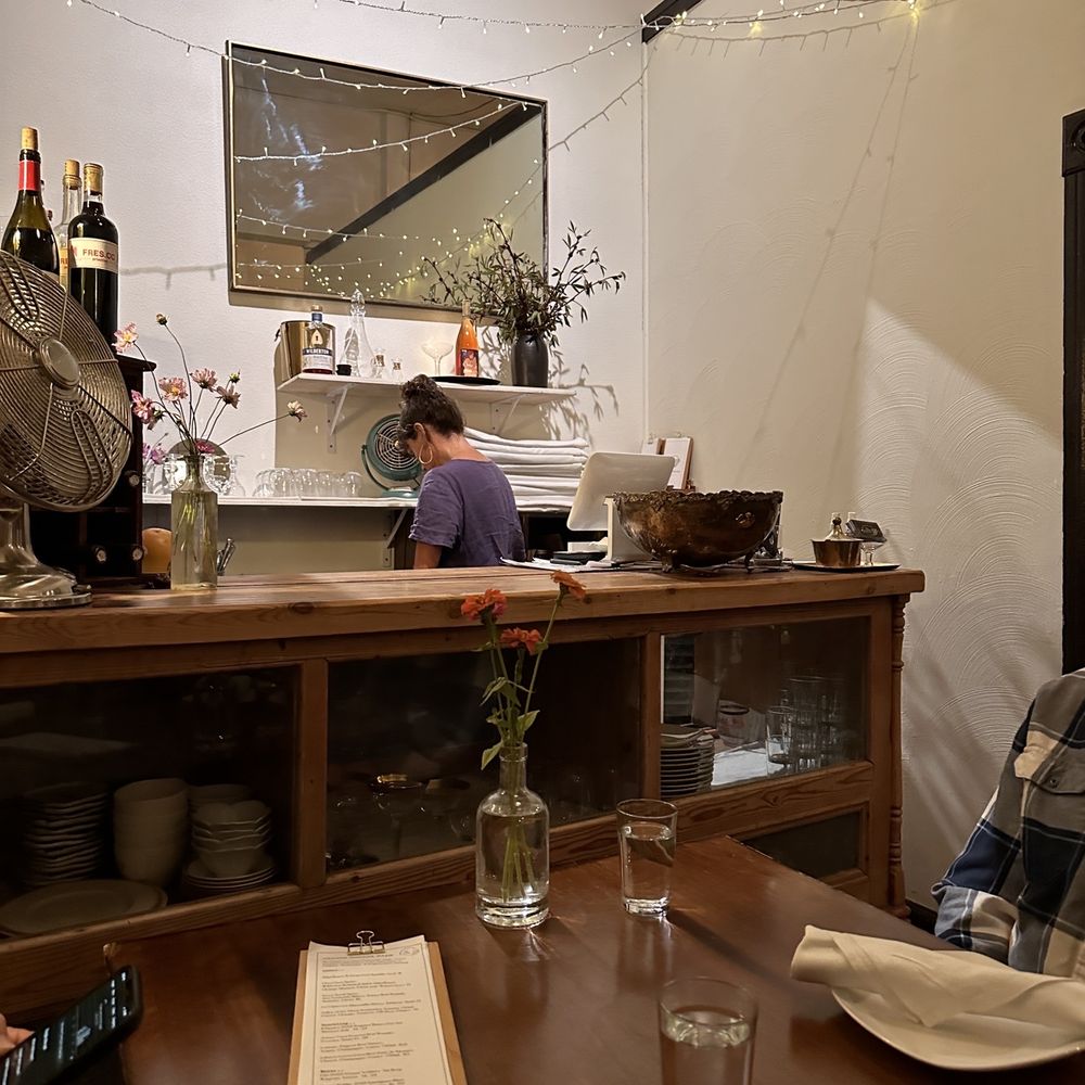 Street Social - a man sitting at a table in a restaurant - New American Near Me - Petaluma, California Street Social - a man sitting at a table in a restaurant - New American Near Me - Petaluma, California