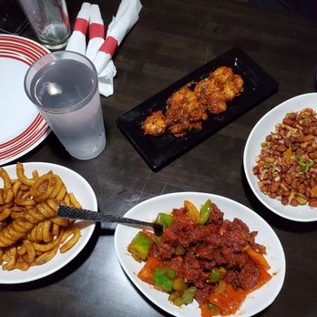 Paradise Indian Grill - Chilli chicken, curly fries and some peanuts. - Indian Near Me - Hiawatha, Iowa