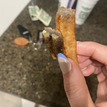 Wingstop - a hand holding a half eaten pastry - Chicken Wings Near Me - Corona, California Wingstop - a hand holding a half eaten pastry - Chicken Wings Near Me - Corona, California