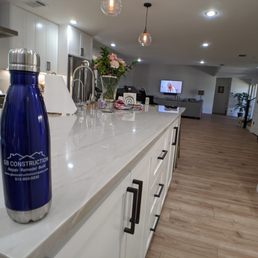 a kitchen counter with a water bottle on it a kitchen counter with a water bottle on it