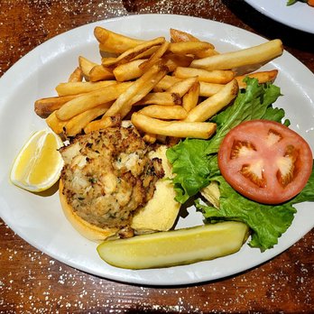 Bassetts Fine Food & Spirits - Jumbo Lump Crab Cake sandwich with hand-cut fries and pickle spear. - New American Near Me - Poolesville, Maryland Bassetts Fine Food & Spirits - Jumbo Lump Crab Cake sandwich with hand-cut fries and pickle spear. - New American Near Me - Poolesville, Maryland