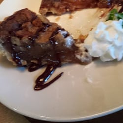 Tupelo Honey Southern Kitchen & Bar - Half eaten brown butter pecan pie with dark chocolate sauce