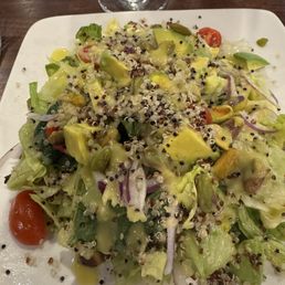 Ensalada Andina - Organic baby kale lettuce with quinoa, tomatoes, red onion, pistachios and homemade citrus avocado vinaigrette