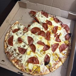 Dontae's Highland Pizza Parlor - Large pizza. 1/2 pep & crumbled sausage, 1/2 pep & banana peppers.