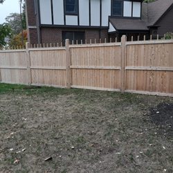 All Solutions Home Services - Stockade fence divides the two houses.