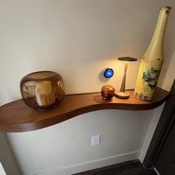 Marina del Rey custom curved Rosen floating shelf  with grooving for LED lights on the top and the bottom and with a custom shadow gap stain