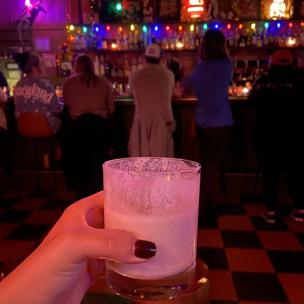Baby Gee - a person holding a glass of beer - Cocktail Bars Near Me - Long Beach, California Baby Gee - a person holding a glass of beer - Cocktail Bars Near Me - Long Beach, California