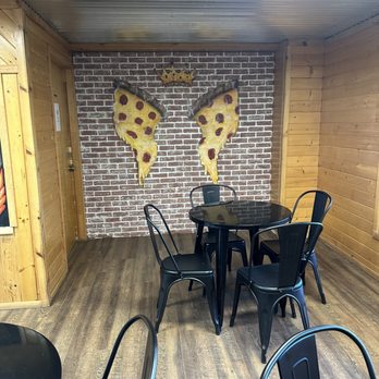 Slice Of Greer - a table and chairs in a restaurant - Pizza Near Me - Greer, Arizona Slice Of Greer - a table and chairs in a restaurant - Pizza Near Me - Greer, Arizona